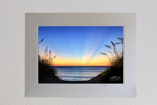 13 x 19 luster print in 18 x 24 ivory ￼￼mat of Dawn light rays on a Outer Banks beach in Duck NC.