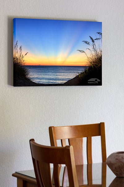 20"x30" x1.5" stretched canvas print hanging in the dining room of Dawn light rays on a Outer Banks beach in Duck NC.