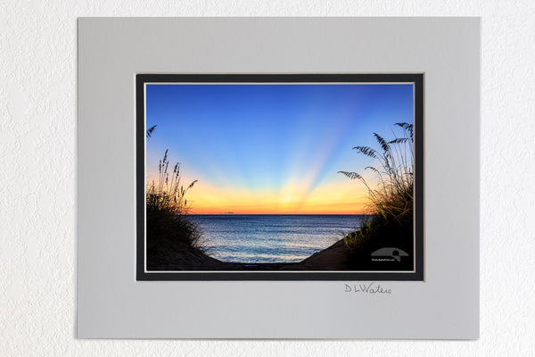 5 x 7 luster prints in a 8 x 10 ivory and black double mat of  Dawn light rays on a Outer Banks beach in Duck NC.