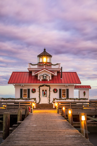 Roanoke Marshes Lighthouse decorated for Christmas at sunset on the waterfront at Manteo Outer Banks North Carolina.