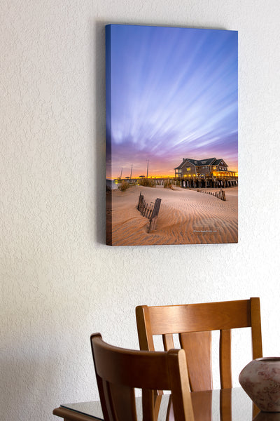 20"x30" x1.5" stretched canvas print hanging in the dining room of Cloud streaks in the sky, a result of two minute exposure time, above Jennette's pier Nags Head on the Outer Banks of North Carolina.