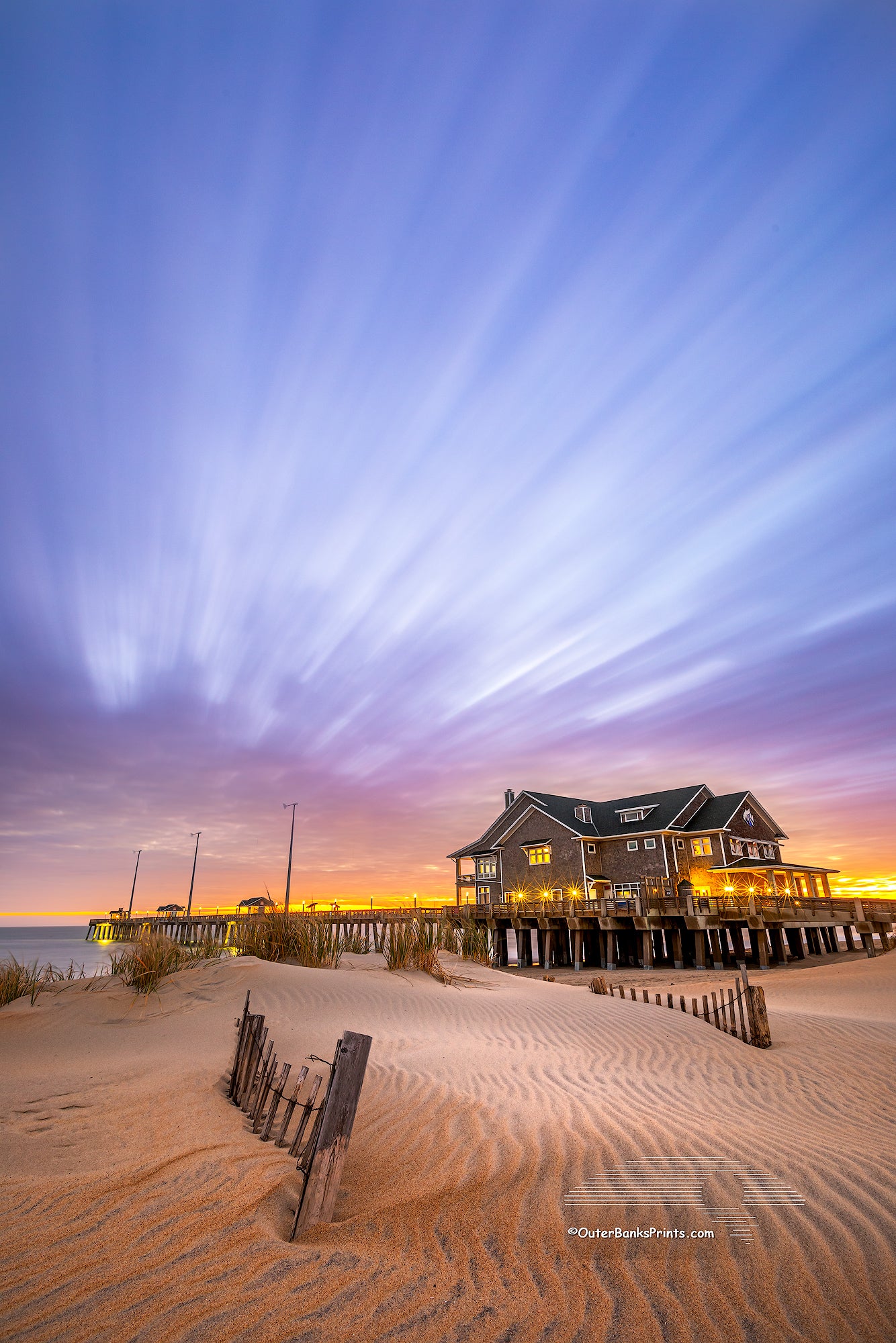 Cloud streaks in the sky, a result of  two minute exposure time, above Jennette's pier Nags Head on the Outer Banks of North Carolina