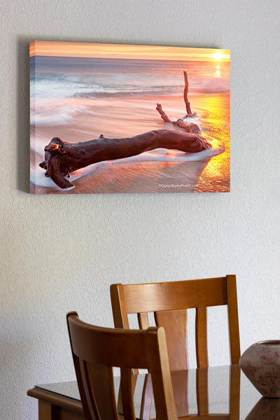20"x30" x1.5" stretched canvas print hanging in the dining room of A long exposure of driftwood washed by the waves at sunrise at Kitty Hawk beach on the Outer Banks of NC.
