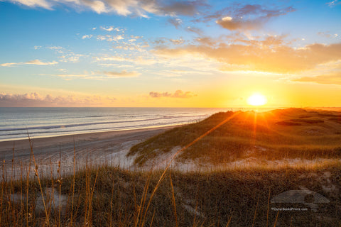 Sun setting over sanddunes along the Frisco costline in Cape Hatteras National Seashore, NC.