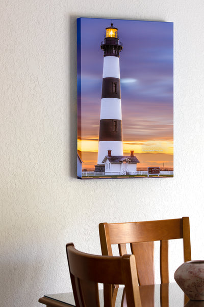 20"x30" x1.5" stretched canvas print hanging in the dining room of A long exposure of Bodie Island Lighthouse on the Outer Banks, reveals movement in the clouds at sunrise.
