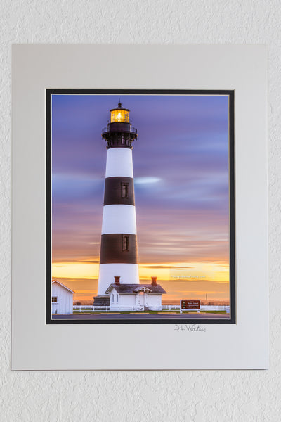 8 x 10 luster print in a 11 x 14 ivory and black double mat of A long exposure of Bodie Island Lighthouse on the Outer Banks, reveals movement in the clouds at sunrise.