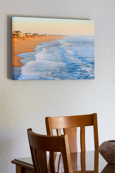 20"x30" x1.5" stretched canvas print hanging in the dining room of Empty beach photographed from Kitty Hawk Fishing Pier on the Outer Banks of NC.