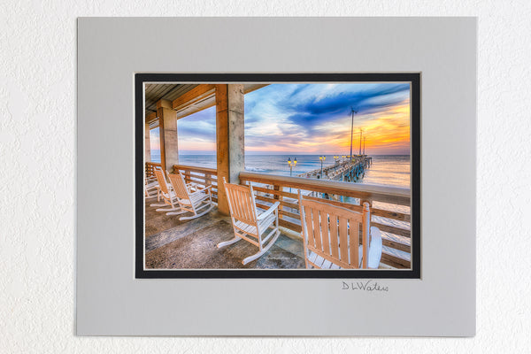 5 x 7 luster prints in a 8 x 10 ivory and black double mat of  A line of rocking chairs looking out over Jennette's Pier in Nags Head, NC.