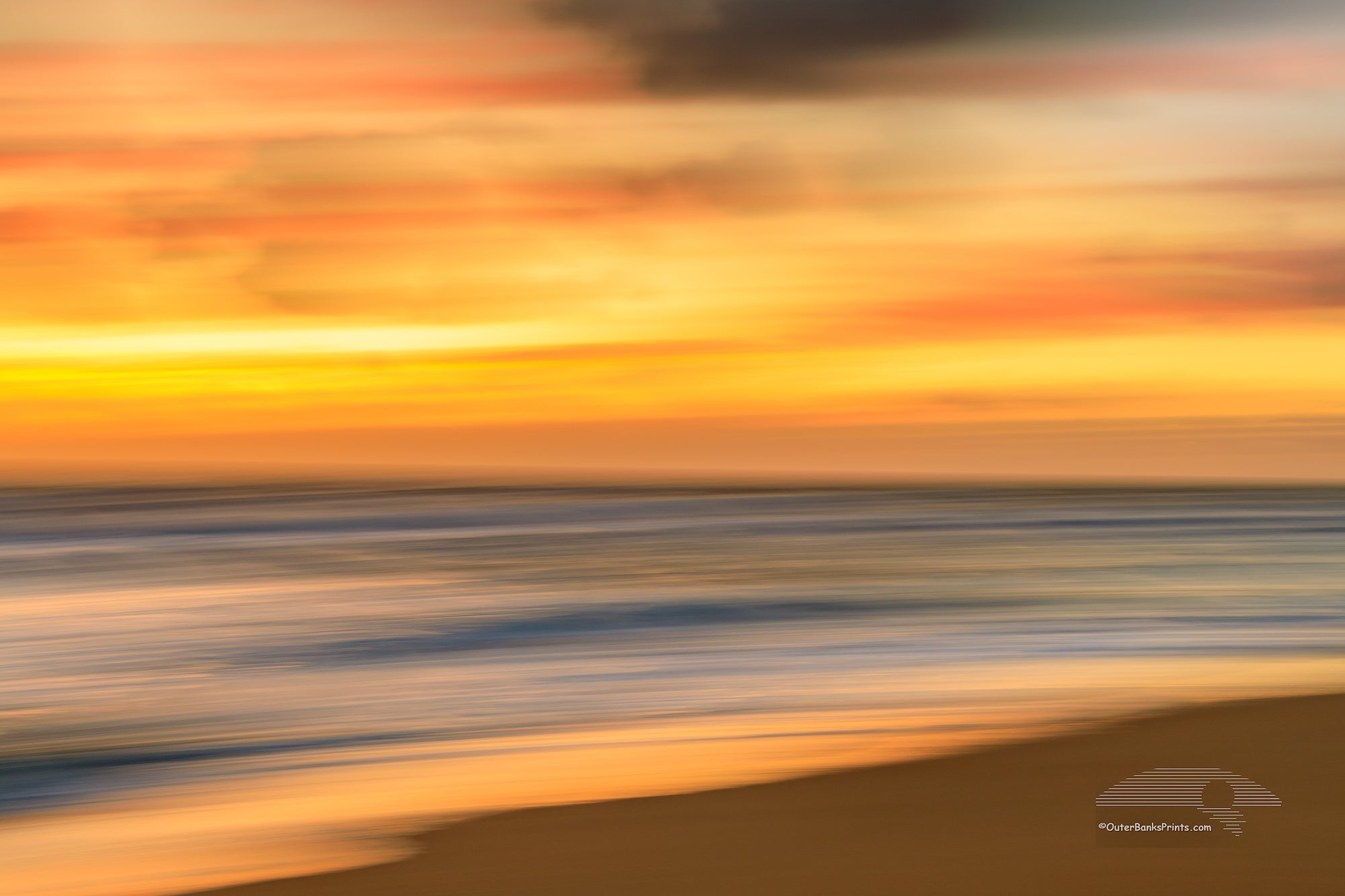 Soft gold sunrise Beach photo was created by using a long shutter speed and moving the camera a Kill Devil Hills beach on the outer banks of NC.