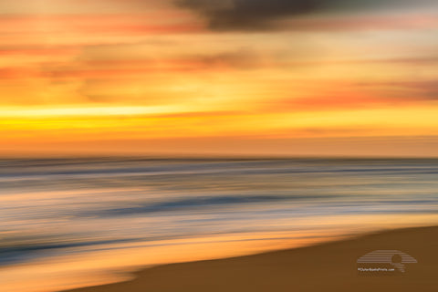 Soft gold sunrise Beach photo was created by using a long shutter speed and moving the camera a Kill Devil Hills beach on the outer banks of NC.