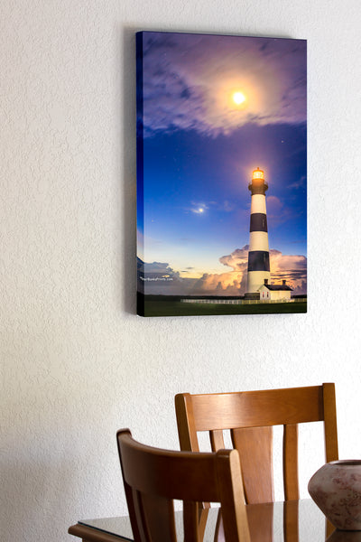 20"x30" x1.5" stretched canvas print hanging in the dining room of Bodie Island Lighthouse in a summer heat lightning storm under a full moon.