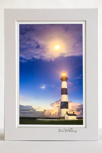 4 x 6 luster print in a 5 x 7 ivory mat of Bodie Island Lighthouse in a summer heat lightning storm under a full moon.