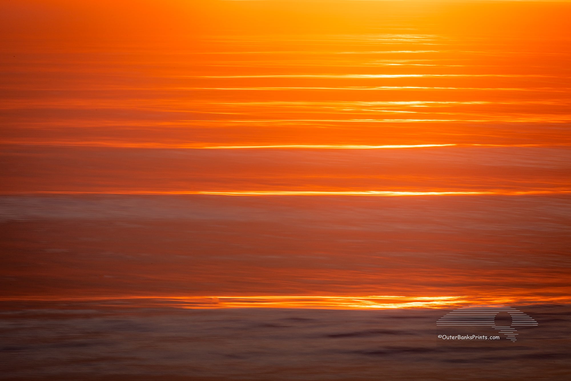 Kitty Hawk Surf at sunrise with a long shutter speed and camera movement.