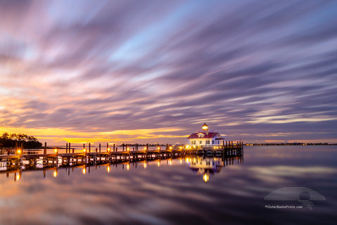 This two minute long exposure before sunrise shows the clouds moving past Roanoke Marshes Lighthouse in Manteo on the Outer Banks of North Carolina. This  lighthouse is a replica of a river lighthouse that was located at in the sound in Wanchese