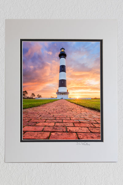 8 x 10 luster print in a 11 x 14 ivory and black double mat of A brick path leading to Bodie Island Lighthouse at sunrise on the Outer Banks of North Carolina.
