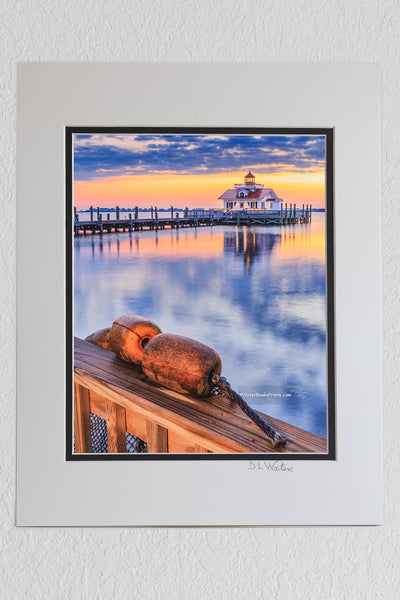 8 x 10 luster print in a 11 x 14 ivory and black double mat of Roanoke Marshes Lighthouse and buoys at Christmas time in Manteo on the Outer Banks
