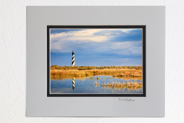 5 x 7 luster prints in a 8 x 10 ivory and black double mat of  Cape Hatteras lighthouse reflected in the wild marshy landscape on the Outer Banks of NC.