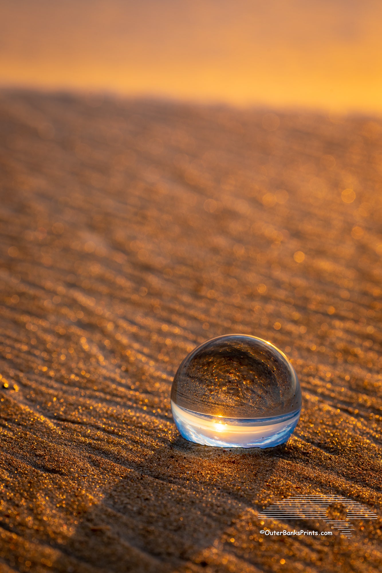 The last photo of this crystal ball at Coquina Beach, South of Nags Head before the surf took it out to sea. In the future it should make an awesome piece of Seaglass for the person lucky enough to find it!