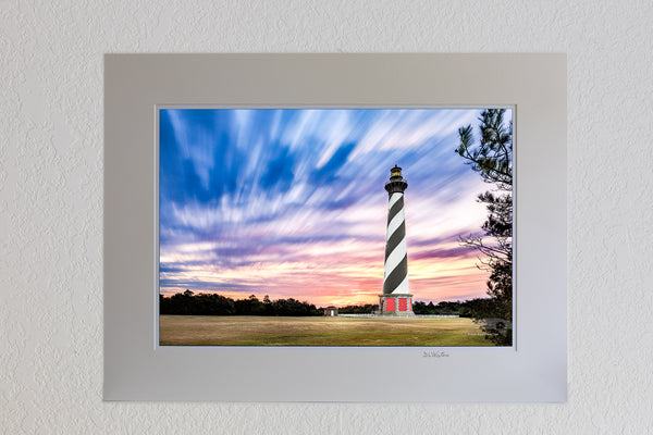 13 x 19 luster print in 18 x 24 ivory ￼￼mat of A long exposure of clouds and Cape Hatteras Lighthouse on the Outer Banks of NC.