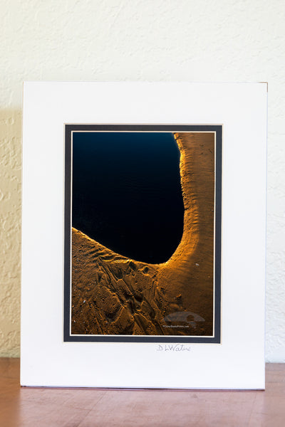 5 x 7 luster print in a 8x10 ivory and black double mat of Morning light reflecting off the sand at the edge of the tide pool.