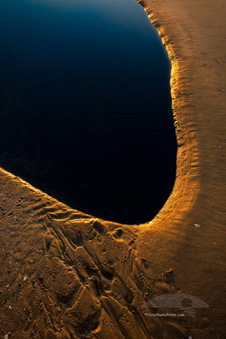 Morning light reflecting off the sand at the edge of the tide pool.