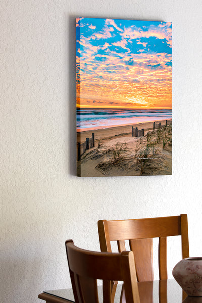20"x30" x1.5" stretched canvas print hanging in the dining room of A beautiful sunrise over Kitty Hawk Beach on the Outer Banks of NC.