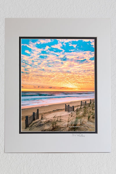 8 x 10 luster print in a 11 x 14 ivory and black double mat of A beautiful sunrise over Kitty Hawk Beach on the Outer Banks of NC.