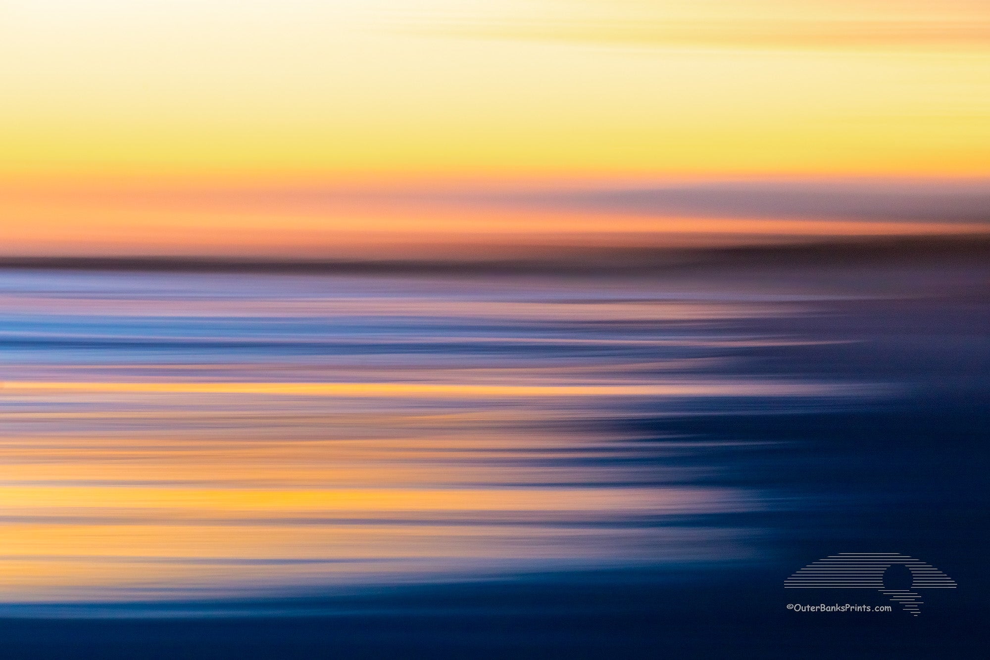 Intentional camera movement to create long streaks of light at sunset along Frisco beach in Cape Hatteras National Seashore, NC.