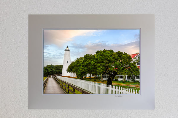 13 x 19 luster print in 18 x 24 ivory ￼￼mat of Sunrise on a stormy morning at Ocracoke Lighthouse.