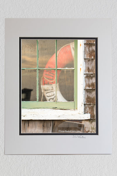 8 x 10 luster print in a 11 x 14 ivory and black double mat of Picture of a old window and lifesaver at Chicamacomico Lifesaving Satiation on Hatteras Island.
