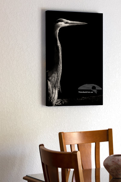 20"x30" x1.5" stretched canvas print hanging in the dining room of A Great Blue Heron emerging from the shadows on the Outer Banks of NC.