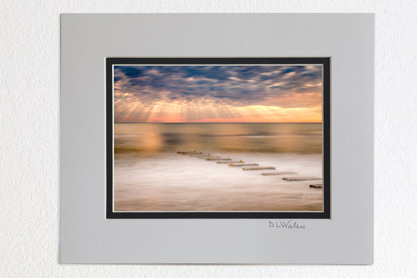  5 x 7 luster prints in a 8 x 10 ivory and black double mat of  Long exposure of an amazing sky and a drainage outflow in Nags Head on the Outer Banks of NC.