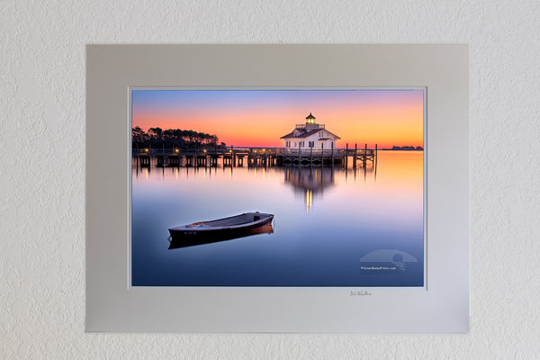 13 x 19 luster print in 18 x 24 ivory ￼￼mat of Roanoke Marshes Lighthouse On the waterfront of Manteo,NC, the Roanoke Marshes Light is a reconstruction of the square cottage-style screw-pile lighthouse which stood at the southern entrance to Croatan Sound, near Wanchese.  