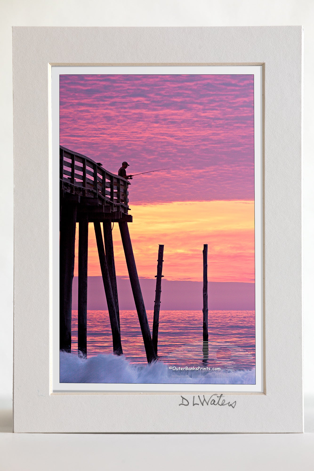4 x 6 luster print in a 5 x 7 ivory mat of  A silhouette of an incredible sunrise at Kitty Hawk pier.