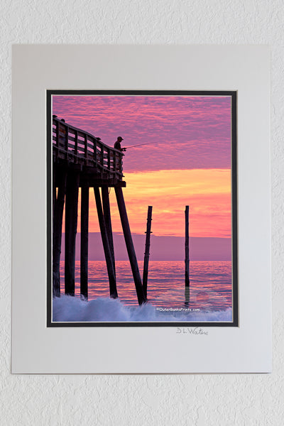 8 x 10 luster print in a 11 x 14 ivory and black double mat of A silhouette of an incredible sunrise at Kitty Hawk pier.