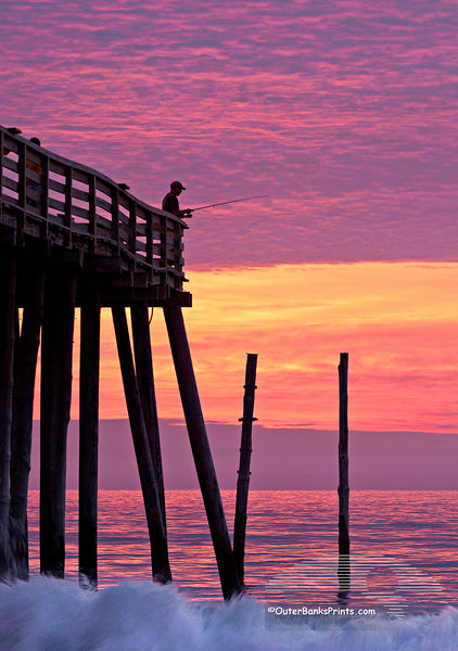 A silhouette of an incredible sunrise at Kitty Hawk pier.