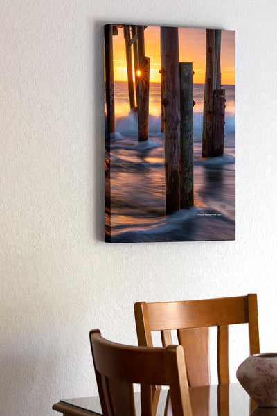 20"x30" x1.5" stretched canvas print hanging in the dining room of Long exposure of the surf and a sun star under Avalon Fishing Pier in Kill Devil Hills on the Outer Banks.