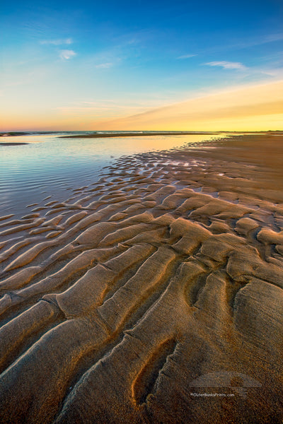 Ripples of sand become visible as the tide receds at Oregon Inlet in the Cape Hatteras National Seashore on the Outer Banks of North Carolina.