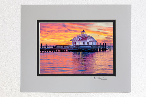 5 x 7 luster prints in a 8 x 10 ivory and black double mat of  A fabulous sunrise at Roanoke Marshes Lighthouse on Shallow Bag Bay in Manteo North Carolina.