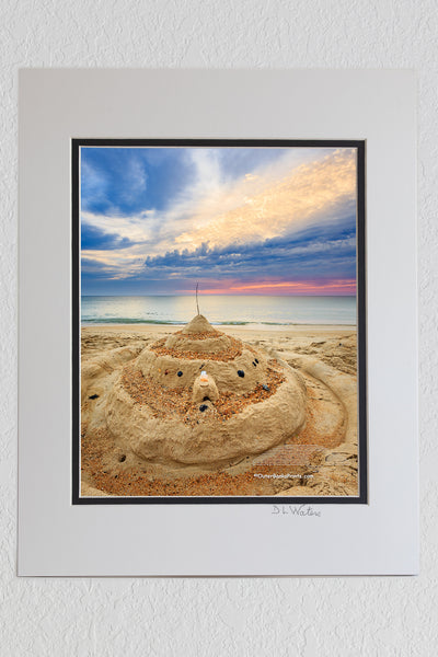 8 x 10 luster print in a 11 x 14 ivory and black double mat of Sunrise sandcastle in Kitty Hawk, NC on the Outer Banks.