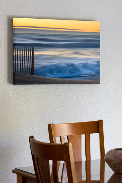 20"x30" x1.5" stretched canvas print hanging in the dining room of This photo was taken with a heavy wind blowing the surf into a frenzy. There was no beach to walk on and every fifth wave came over the dune. The contrast between the foreground sand fence, and the moving waves in the background helps to convey a real sense of motion.