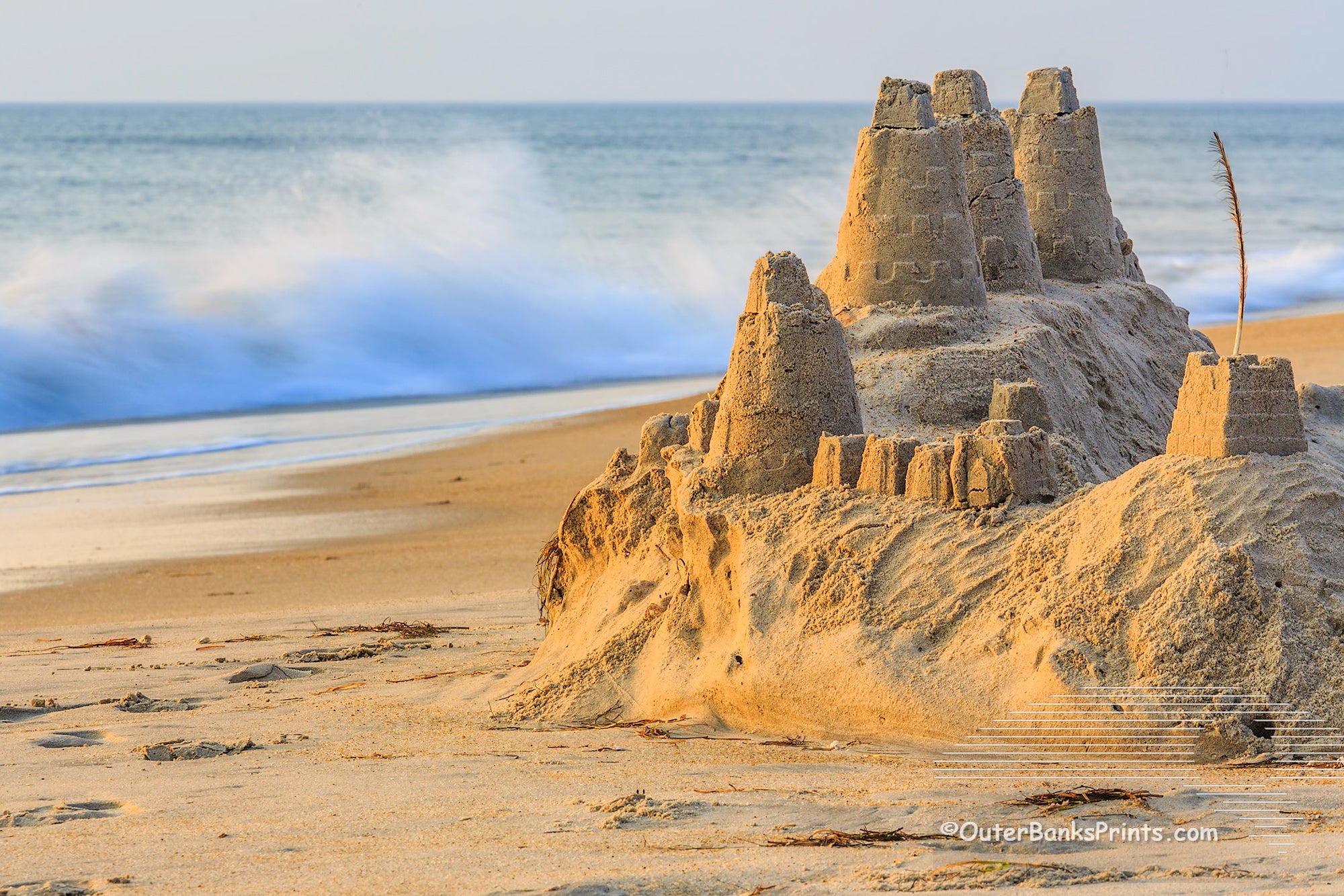 The high tide close ing in on this sand castle in Duck, NC.