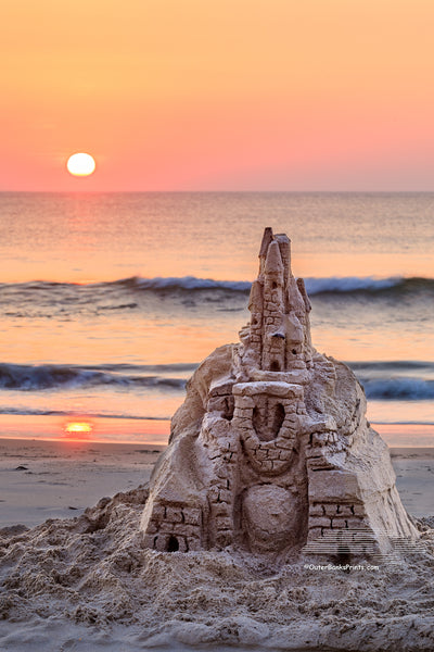 The sun rises over an elaborate sand castle in Corolla on the Outer Banks NC.