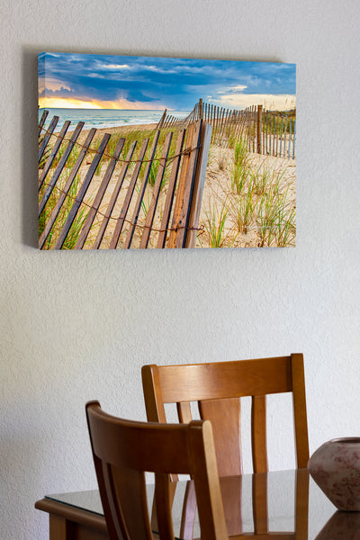 20"x30" x1.5" stretched canvas print hanging in the dining room of Summer storm on the coast of NC at Kitty Hawk. The sand fence and sea oats make for a dramatic foreground with the summer beach storm in the background.