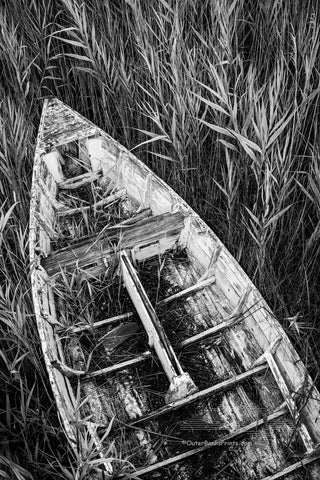An abandon skiff in the reeds along the Manteo waterfront on the Outer Banks in NC. I set the self timer on my camera and held my tripod high above my head to capture this photograph. I felt this one look best in black-and-white.