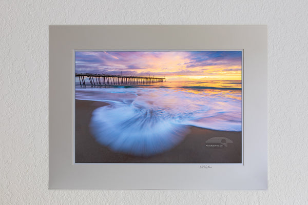 13 x 19 luster print in 18 x 24 ivory ￼￼mat of The surf faning out at the beach in Nags Head with the Nags Head Fishing Pier in the background on the Outer Banks of North Carolina.