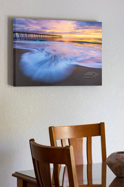 20"x30" x1.5" stretched canvas print hanging in the dining room of The surf faning out at the beach in Nags Head with the Nags Head Fishing Pier in the background on the Outer Banks of North Carolina.