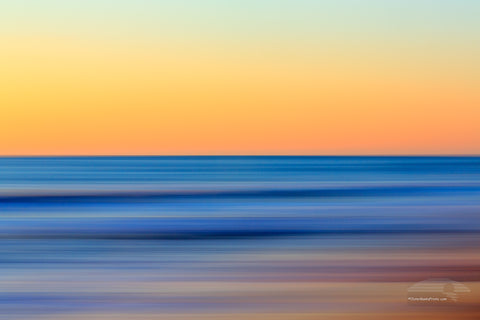 A Outer Banks beach sunrise reduced to colors and lines. Using camera movement during a long exposure to blur the beach and ocean.