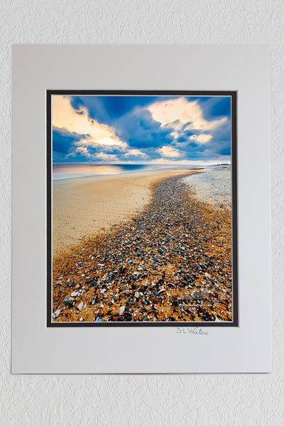 8 x 10 luster print in a 11 x 14 ivory and black double mat of Long exposure of a trail of shell shards washed up on the high tide at Kitty Hawlk Outer Banks beach Christmas morning.