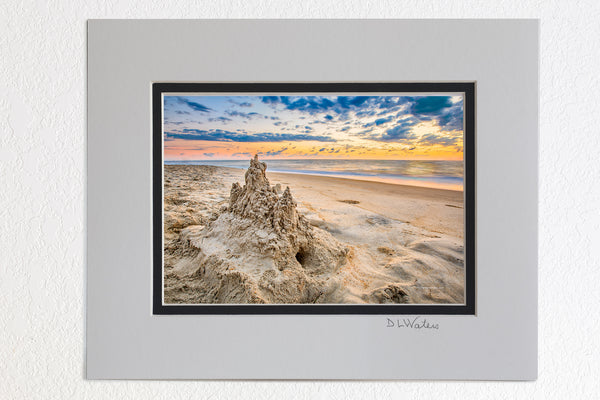 5 x 7 luster prints in a 8 x 10 ivory and black double mat of  A drip sandcastle at sunrise on an Outer Banks beach.